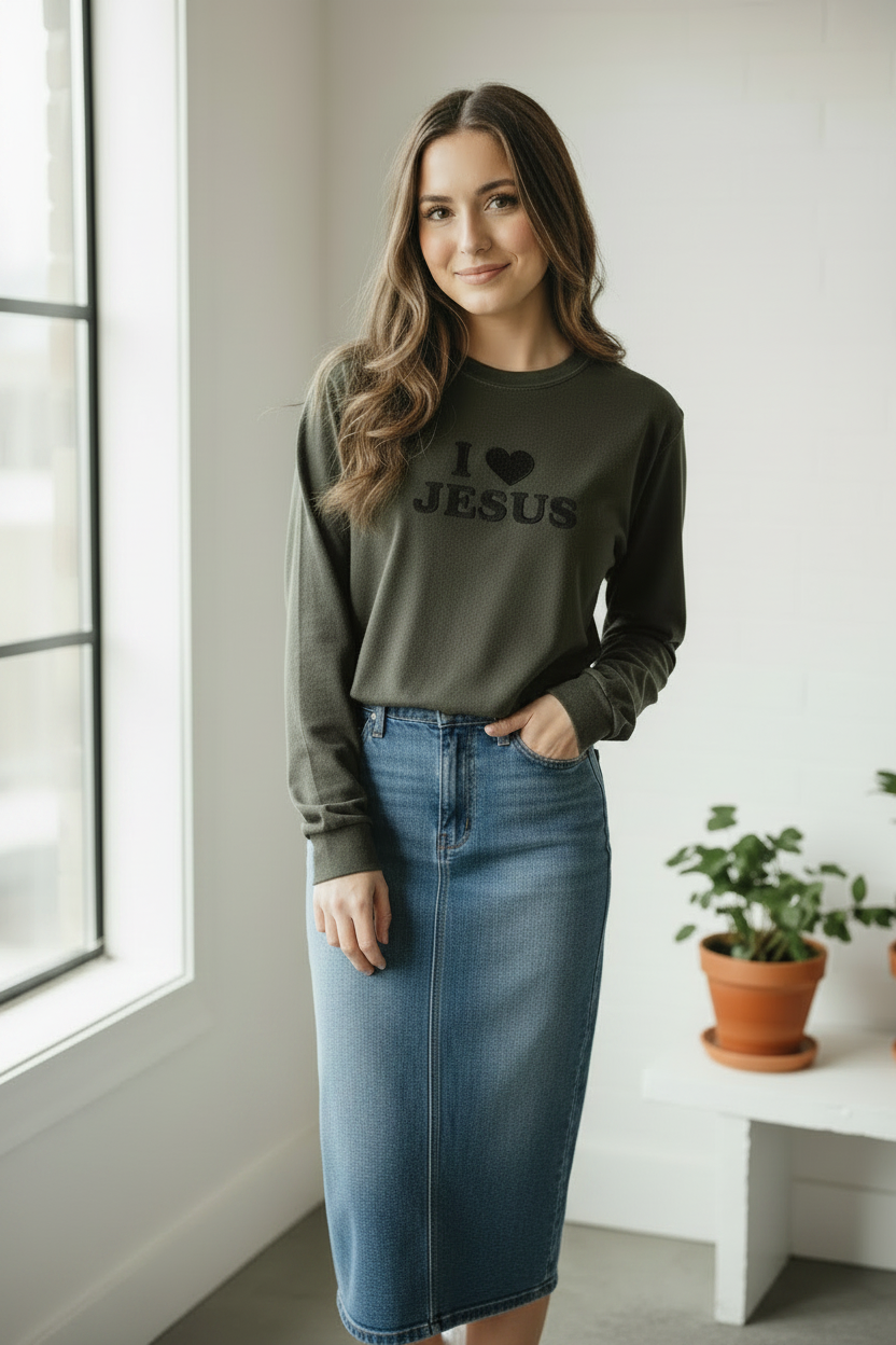 Young woman wearing I Love Jesus shirt with long denim skirt and Adidas sneakers